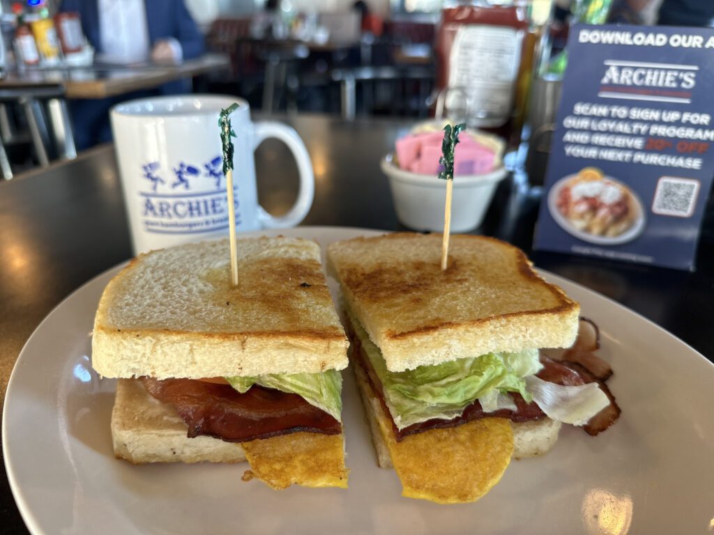 A sandwich cut in half on top of a plate.